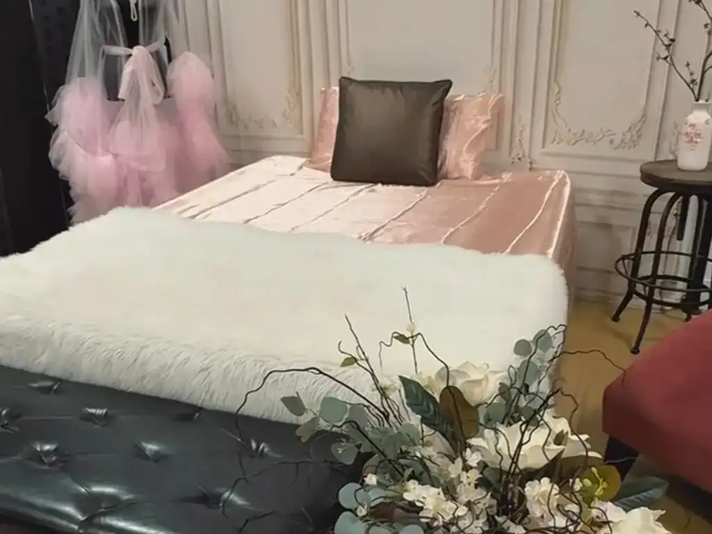 Luxurious bedroom with elegant decor, soft pastel accents, and plush bedding.