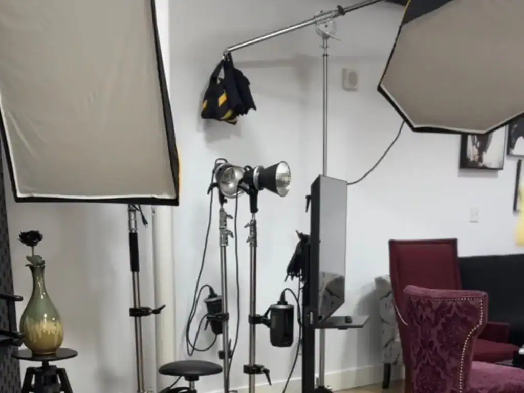 Photography studio with professional lighting equipment and backdrops.