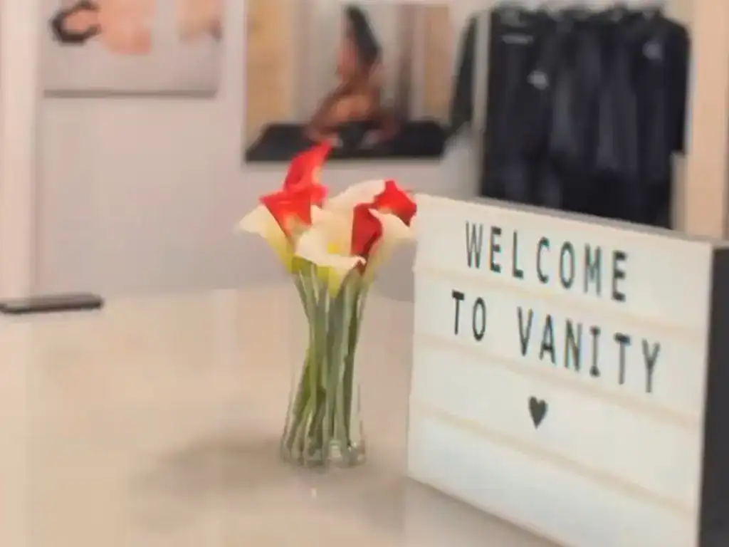 Elegant flower arrangement with "Welcome to Vanity" sign at Vanity Studio.