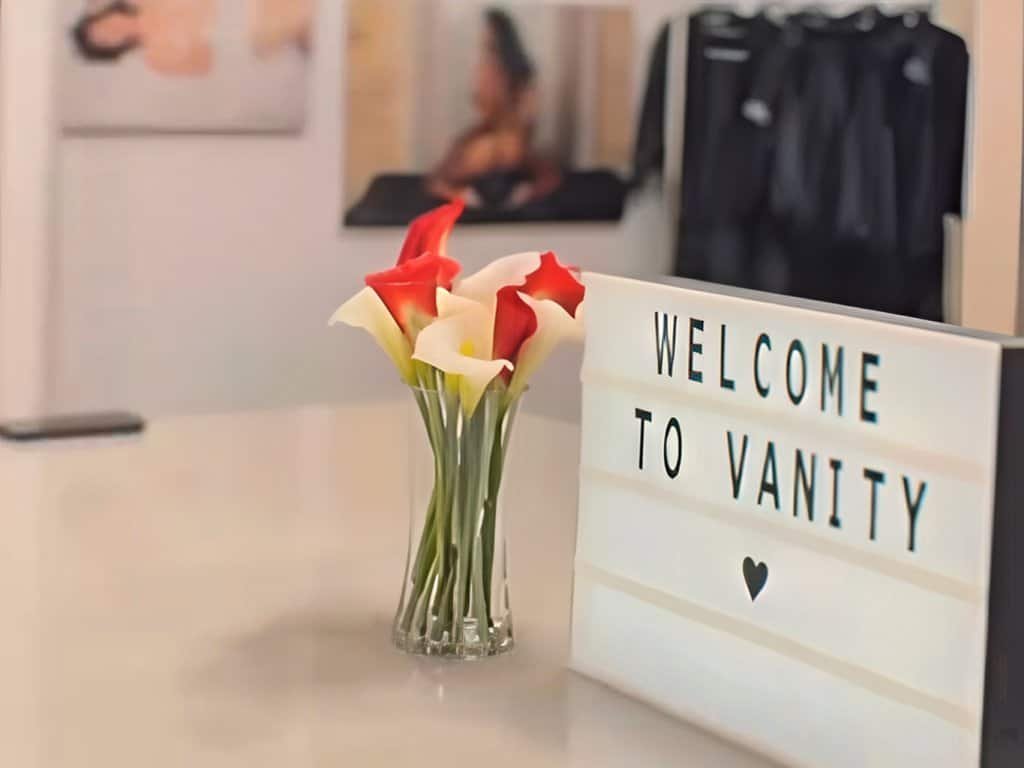Welcome sign with flowers at Vanity Studio, Houston's premier beauty and wellness center.